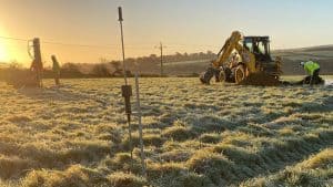 Digger and ground survey at dawn